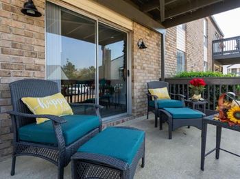 A patio with a chair and a table.
