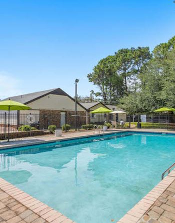 A swimming pool surrounded by a brick border.