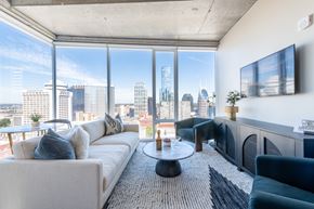 Nashville apartment for rent - A modern living room with a view of the city skyline.