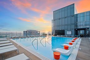 Nashville apartment for rent - a swimming pool on the roof of a building at sunset