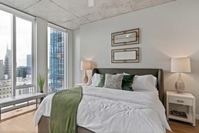 Nashville apartment for rent - a bedroom with a large bed and a large window