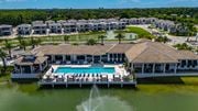 Fort Myers apartment for rent - A large house with a pool in the middle of a lake.
