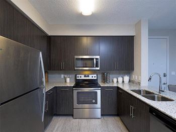 A kitchen with stainless steel appliances and a sink