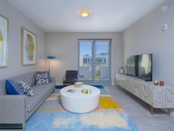 Daytona Beach apartment for rent - a living room with a couch and a coffee table and a tv