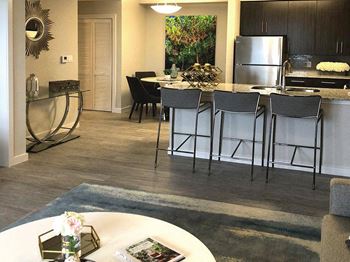 An open kitchen and dining area with bar stools
