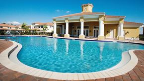Hollywood condo for rent - A pool in front of a house with a blue sky.