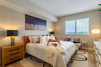 A bedroom with a large bed and a window.