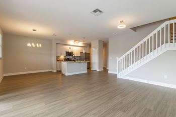 Spacious unfurnished living room with staircase