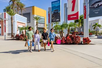 A group of people are walking in front of a building