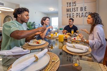 A group of people are having a meal together at a table.