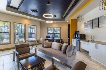Fort Myers apartment for rent - A modern living room with a brown sofa and a glass coffee table.