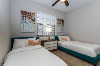 Bedroom with two beds and ceiling fan
