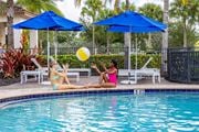Fort Myers apartment for rent - Two women sunbathing by a pool at Portofino Cove, Fort Myers, FL