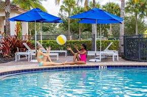 Fort Myers apartment for rent - Two women sunbathing by a pool at Portofino Cove, Fort Myers, FL