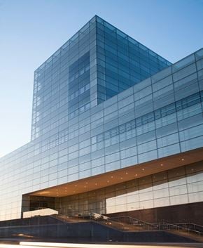 Richmond apartment for rent - a glass building with a blue sky in the background