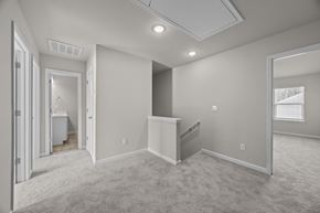 Charlotte apartment for rent - A spacious room with a carpeted floor and a window with blinds.