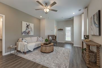 Smyrna apartment for rent - A living room with a white couch and a painting of a horse on the wall.