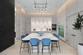 Toronto apartment for rent - a dining room with a marble table and blue chairs