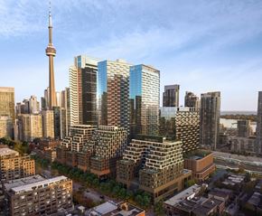 Toronto apartment for rent - A cityscape with a variety of buildings, including a tall tower in the background.