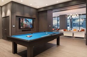 Toronto apartment for rent - a pool table in a living room with a tv