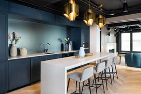 Toronto apartment for rent - a kitchen with blue walls and a long white counter top
