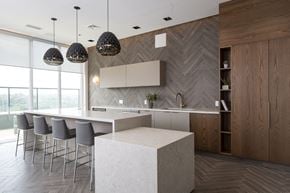 York apartment for rent - a large kitchen with a large white island and chairs