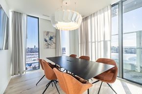 Ottawa apartment for rent - A modern dining room with a large table and chairs.