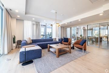 Ottawa apartment for rent - A modern living room with a blue sofa and wooden coffee table.