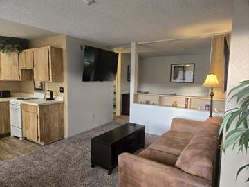 Sierra Vista apartment for rent - A living room with a brown couch and a black coffee table.