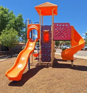 Sierra Vista apartment for rent - A playground with a yellow slide and a purple and orange structure.