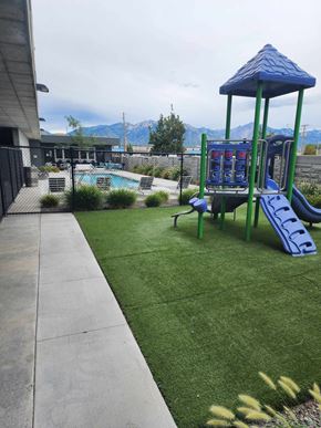 South Salt Lake apartment for rent - A playground with a blue slide and a green swing set.