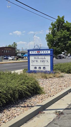 South Salt Lake apartment for rent - A blue sign with the word "UTRAX" on it is in front of a building.