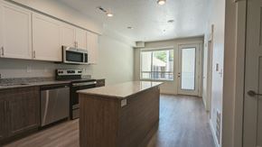 Salt Lake City apartment for rent - A kitchen with an island and a door leading to a balcony