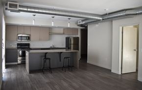 Cleveland apartment for rent - A kitchen with a bar stool and a refrigerator.