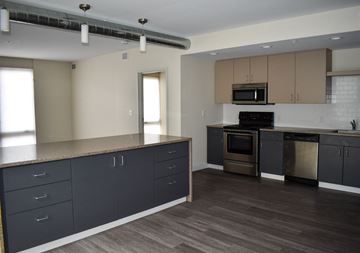 Cleveland apartment for rent - A kitchen with a stove top oven and microwave above it.