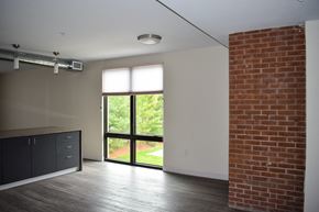 Cleveland apartment for rent - A room with a brick wall and a sliding glass door.