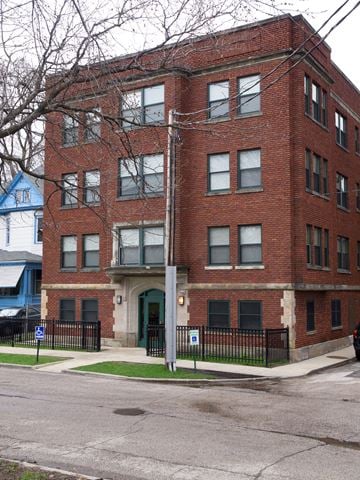 Cleveland apartment for rent - A red brick building with a black fence in front.