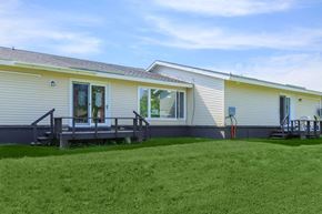 Jonesport apartment for rent - a house with a porch and a grass yard