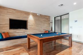 Malden apartment for rent - A pool table with a blue cloth and a television on the wall.