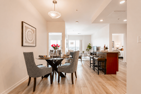 Aurora apartment for rent - A dining room with a table set for four and a chandelier hanging from the ceiling.