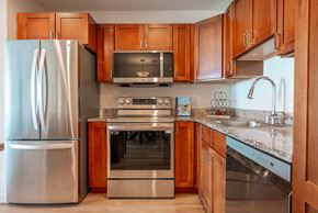 Aurora apartment for rent - A kitchen with wooden cabinets and stainless steel appliances.
