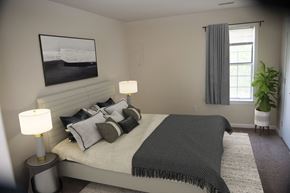 Newport News apartment for rent - a bedroom with a bed and a painting on the wall