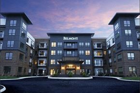 Columbus apartment for rent - an apartment building at dusk with the facade lit up and the name of the building