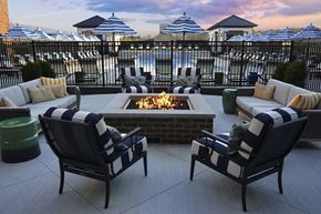 Columbus apartment for rent - a fire pit on a patio with chairs and umbrellas