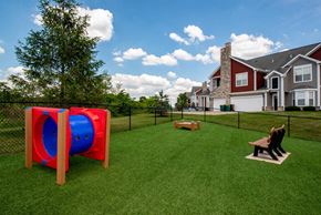Springboro apartment for rent - a yard with a playground and two benches in front of a house
