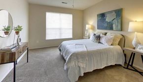 Columbus apartment for rent - a bedroom with a bed and a desk and a window