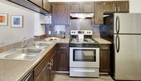 Columbus apartment for rent - a kitchen with stainless steel appliances and wooden cabinets