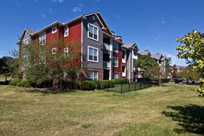 Columbus apartment for rent - an apartment building with a yard in front of it