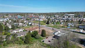 Dieppe apartment for rent - A view of a town with buildings, trees, and a clear sky.