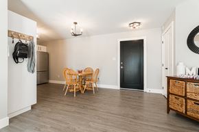 Dieppe apartment for rent - a dining room with a table and chairs and a refrigerator